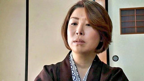 Mature Japanese woman in traditional kimono with pursed lips closeup