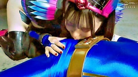 Asian woman in blue cosplay armor kissing strap-on dildo harness