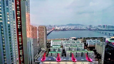 Aerial cityscape view of Korean skyline with river and bridges at dusk