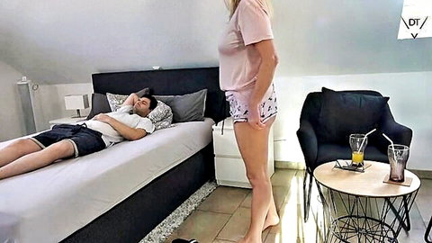 Blonde stepmom in pink top and shorts teases sleeping stepson on bed