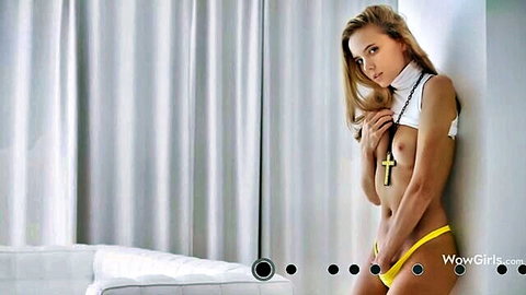 Topless blonde with perky tits in tiny yellow thong and cross necklace posing seductively