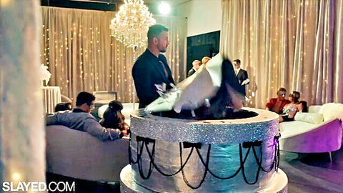 Sexy woman in white lingerie bursts from giant glitter cake at strip club bachelor party