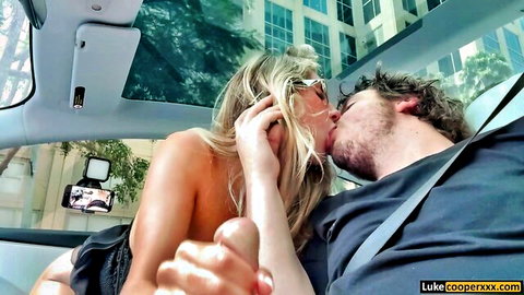 Skinny blonde grabs big cock while kissing bearded guy passionately in public convertible car