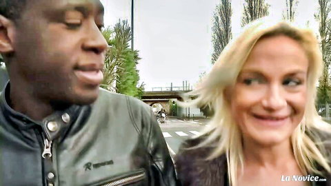 Interracial couple: smiling blonde French woman with Black man outdoors
