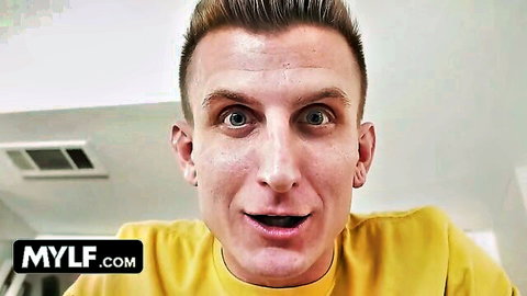 Blonde guy with wide eyes smiling excitedly in yellow shirt on MYLF.com