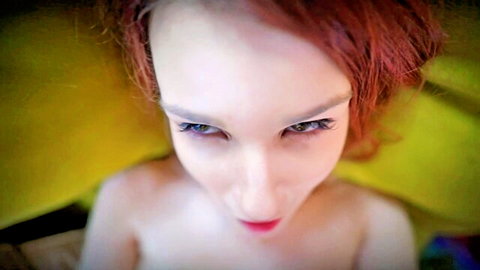 Seductive redhead topless babe stares intensely down with pouty lips in teasing POV