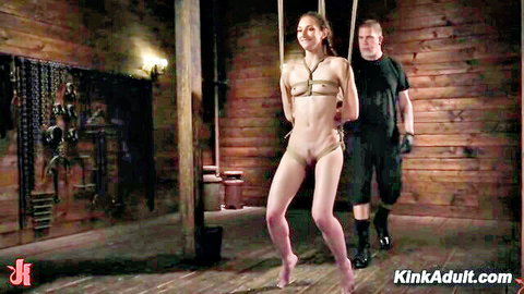 Andi Rose suspended in rope bondage by dominant man in BDSM scene