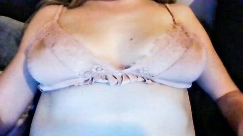 Blonde teen webcam girl teasing in sheer pink lace bra with medium tits and deep cleavage