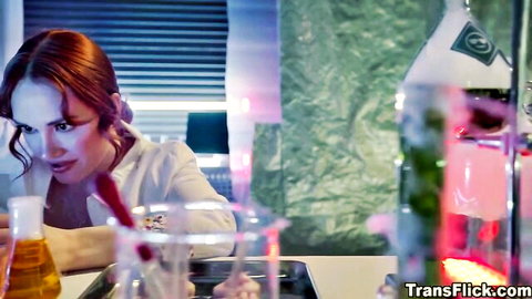 Redhead scientist in white lab coat with beakers, teasing in sex lab
