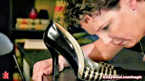 Lotus Lain as bound cougar sniffing black high heel in fetish scene