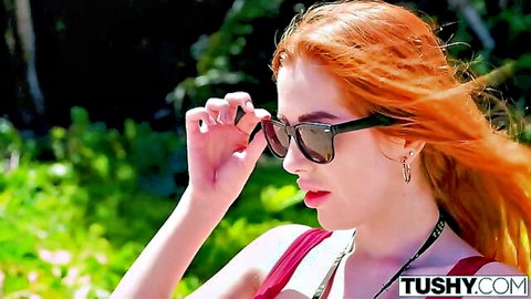 Bodacious redhead Scarlett teasing in pink top and sunglasses outdoors