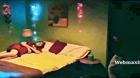 Seductive Indian woman in red dress lying on bed, Ullu series Ek Baar Aur