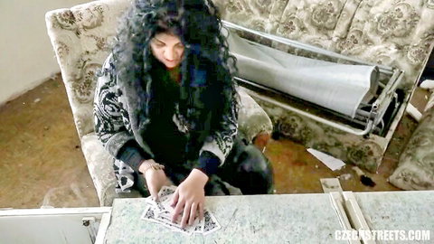 Curly-haired Czech gypsy woman in black top counting cash, amateur style