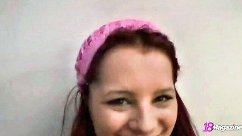 Piper Fawn smiling seductively with pink headband, red hair close-up