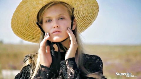 Blonde Dasha in straw hat and sexy lace dress outdoors