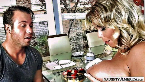 Amber Lynn Bach teases with strawberries on massive bare tits at dinner