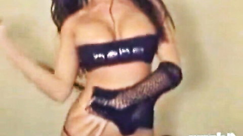 Busty Nicole in sexy black lingerie and gloves, seductive pose