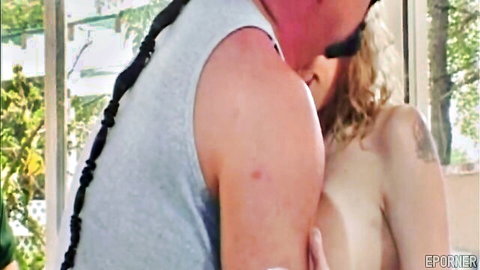 Stunning blonde MILF temptress kissing muscular man passionately