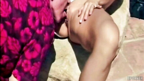 Lesbian babe in floral dress sucks topless woman's big tits outdoors