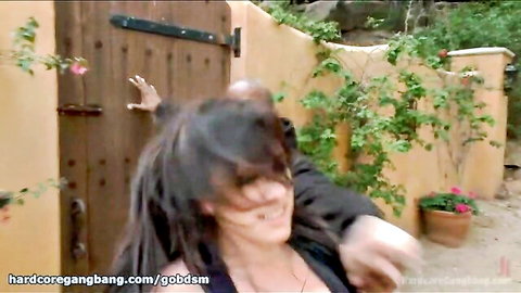 Brunette with dreads grabbed roughly by black man's hand outdoors at door