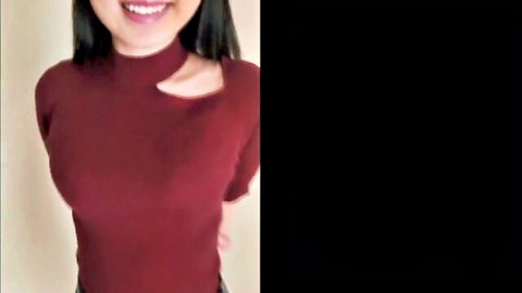 Smiling Asian beauty in sexy maroon turtleneck with cleavage tease