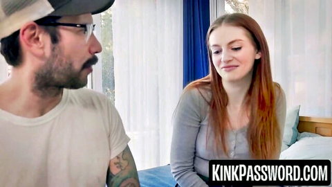 Redhead Maya Kendrick in gray sweater chats intimately with bearded man in bedroom