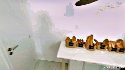 Brown paper bags overflowing with ripe bananas on a white table in a plain room