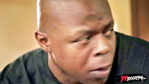 Bald black man with wide-eyed surprised expression closeup in black shirt