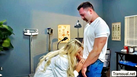 Blonde TS doctor in white coat touches patient's crotch in medical exam
