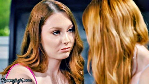 Two busty redhead lesbians staring passionately face-to-face intimately