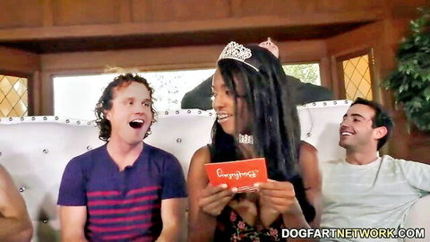 Daya Knight in birthday gangbang with two men, smiling on couch in crown