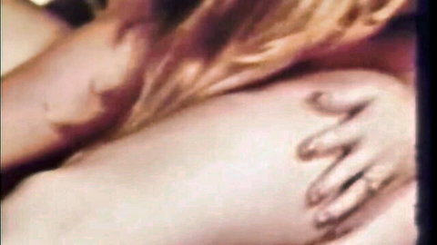 Blonde woman nude side view with hand gripping hip in intimate scene