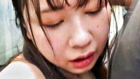Close-up of cute Asian woman with wet hair and aroused expression in JAV