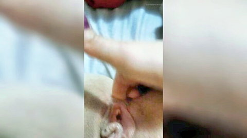 Closeup of fingers inserted deep into wet pink pussy lips