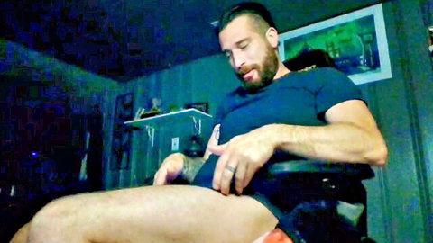 Muscular bearded man exposing cock and masturbating solo