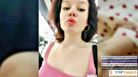 Redhead cam girl NaughtyKatrina pouts lips teasing cleavage in tight pink top