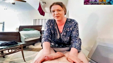 Busty mature MILF spreads legs wide teasing deep cleavage and thighs in open floral blouse