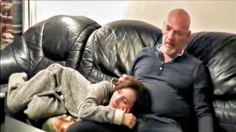 Bald stepdad caresses sleeping brunette stepdaughter on couch