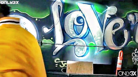 Buxom Catalina Taylor poses seductively near glowing LOVE graffiti wall
