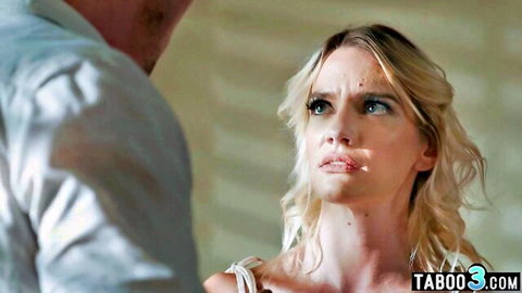Blonde MILF with glossy lips stares intensely at man in taboo confrontation