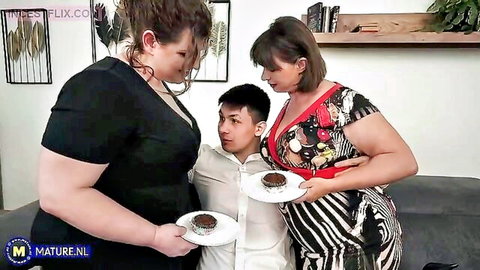 Busty BBW and curvy MILFs in tight dresses feed brownies to young Asian guy in taboo tease