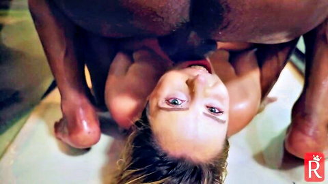 Blonde woman with tongue out under black man's huge ass balls and cock in interracial facesitting