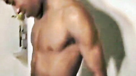 Muscular black man shirtless in steamy shower, solo pose