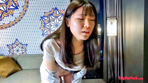 Asian office lady in white shirt leaning forward, teasing view