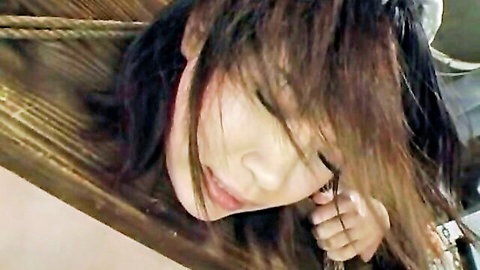 Seductive close-up of Asian woman with long dark hair, eyes half-closed