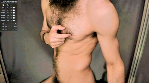Hairy muscular bearded man pinching nipple exposing cock and bush in webcam