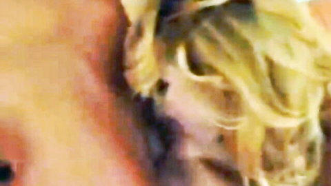 Blonde woman with curly hair in close-up intimate scene from Sperm Swap video