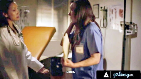 Sinn Sage in blue scrubs with Asian doctor in steamy medical exam scene