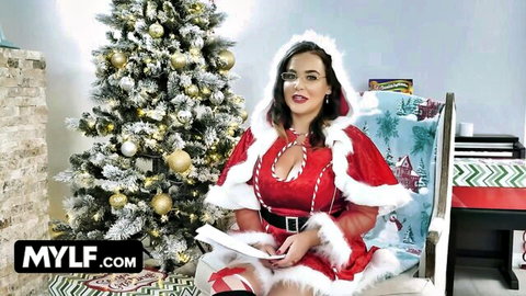 Busty MILF in sexy red Santa cosplay lingerie posing with deep cleavage and stockings