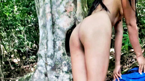 Nude Asian woman bending over in Sri Lankan jungle, exposing big round ass